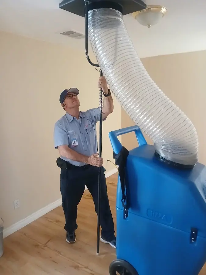 Furnace Tune-Up technician using HEPA equipment in Winslow